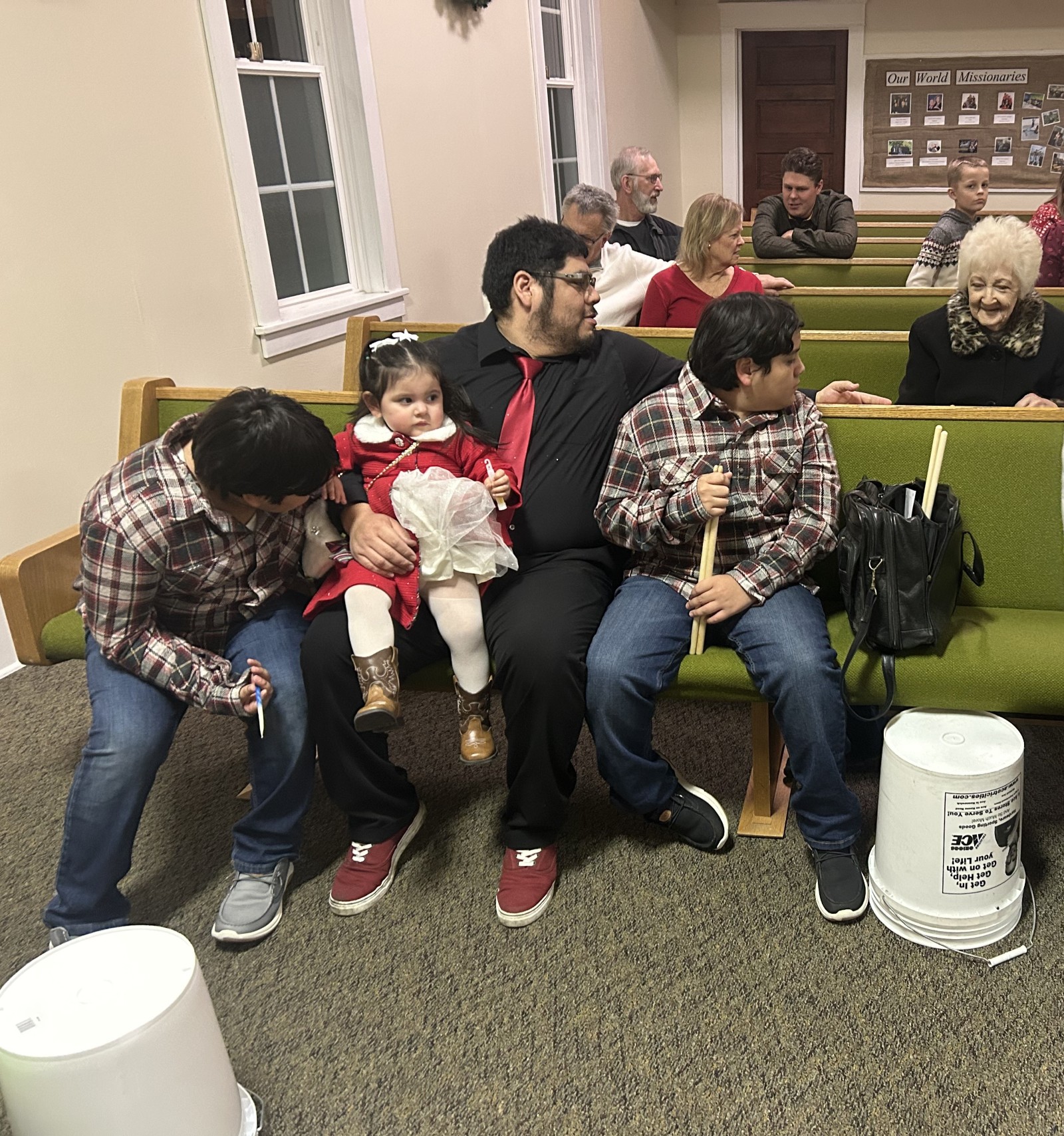 Great Grandma sitting next to her three great grandchildren and the children's Father. Church Christmas Play.