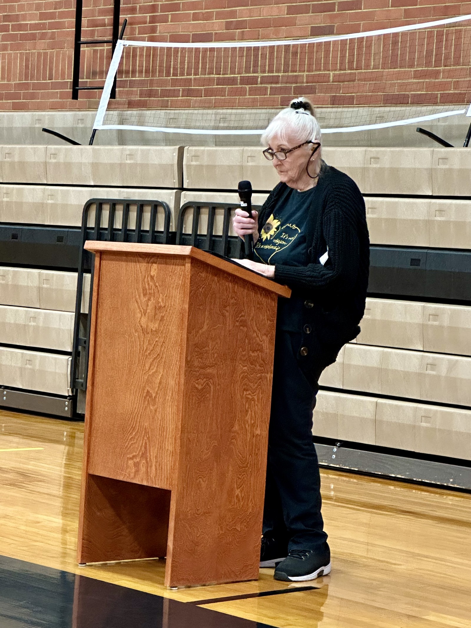 Barbara speaking at a podium for an event.