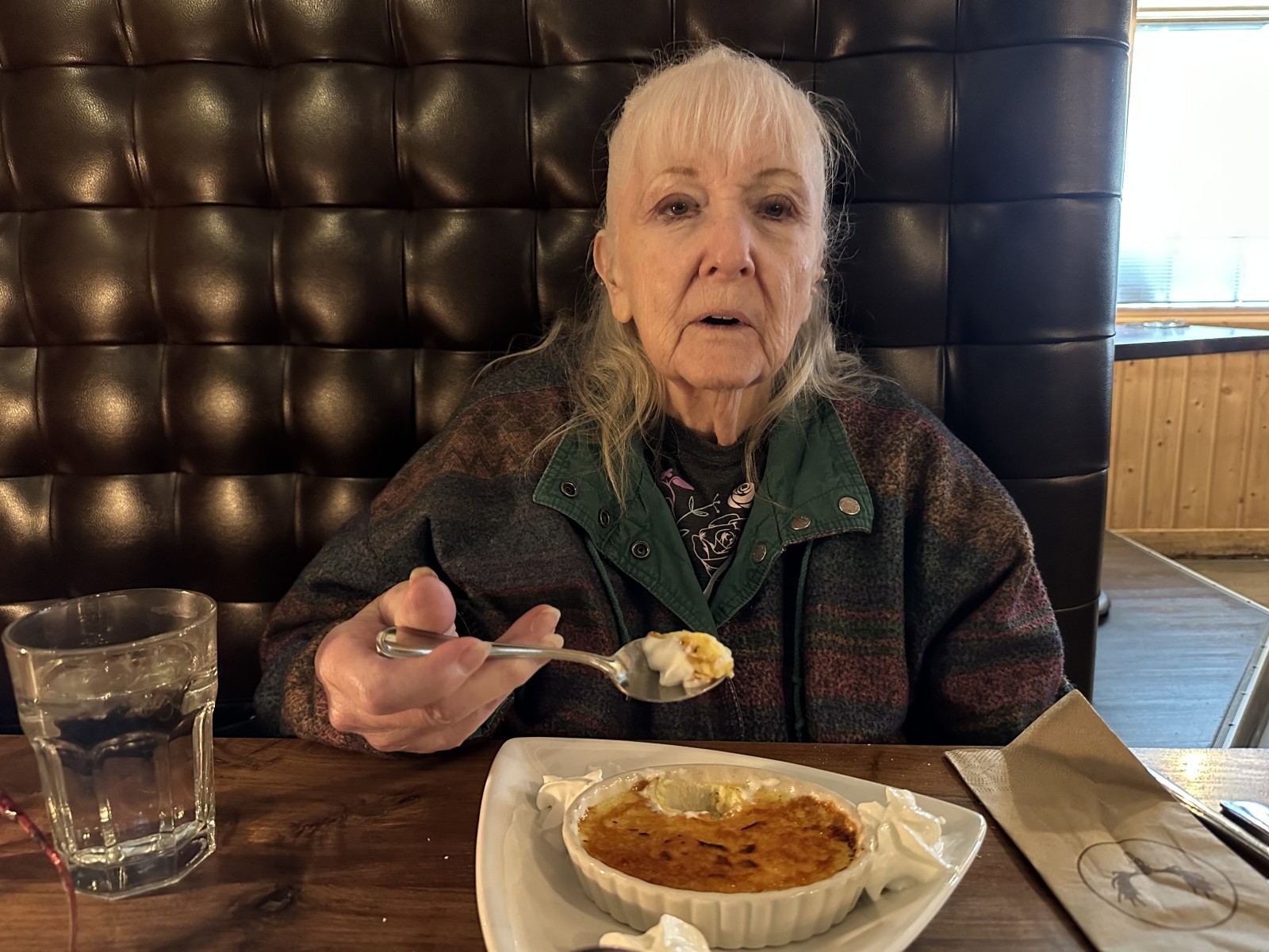Barbara sitting at a restaurant eating.