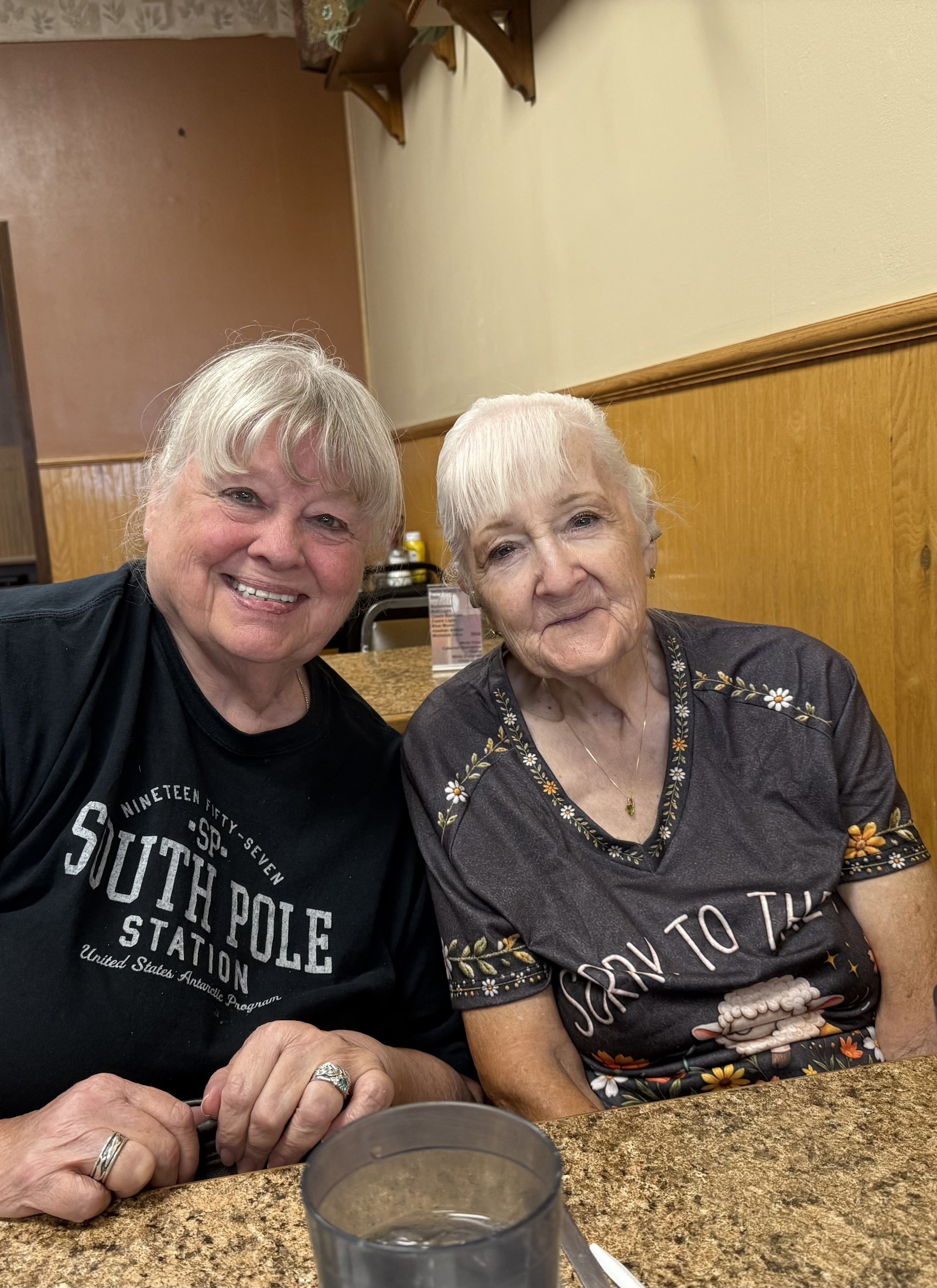Barbara and Franny sitting next to each other at a restaurant.